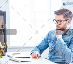 demo-attachment-115-thoughtful-designer-using-graphic-tablet-and-PSG7EPE